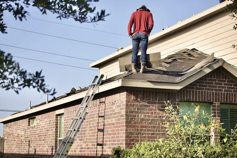 Professional roofer working on a residential roof in Wolf Star